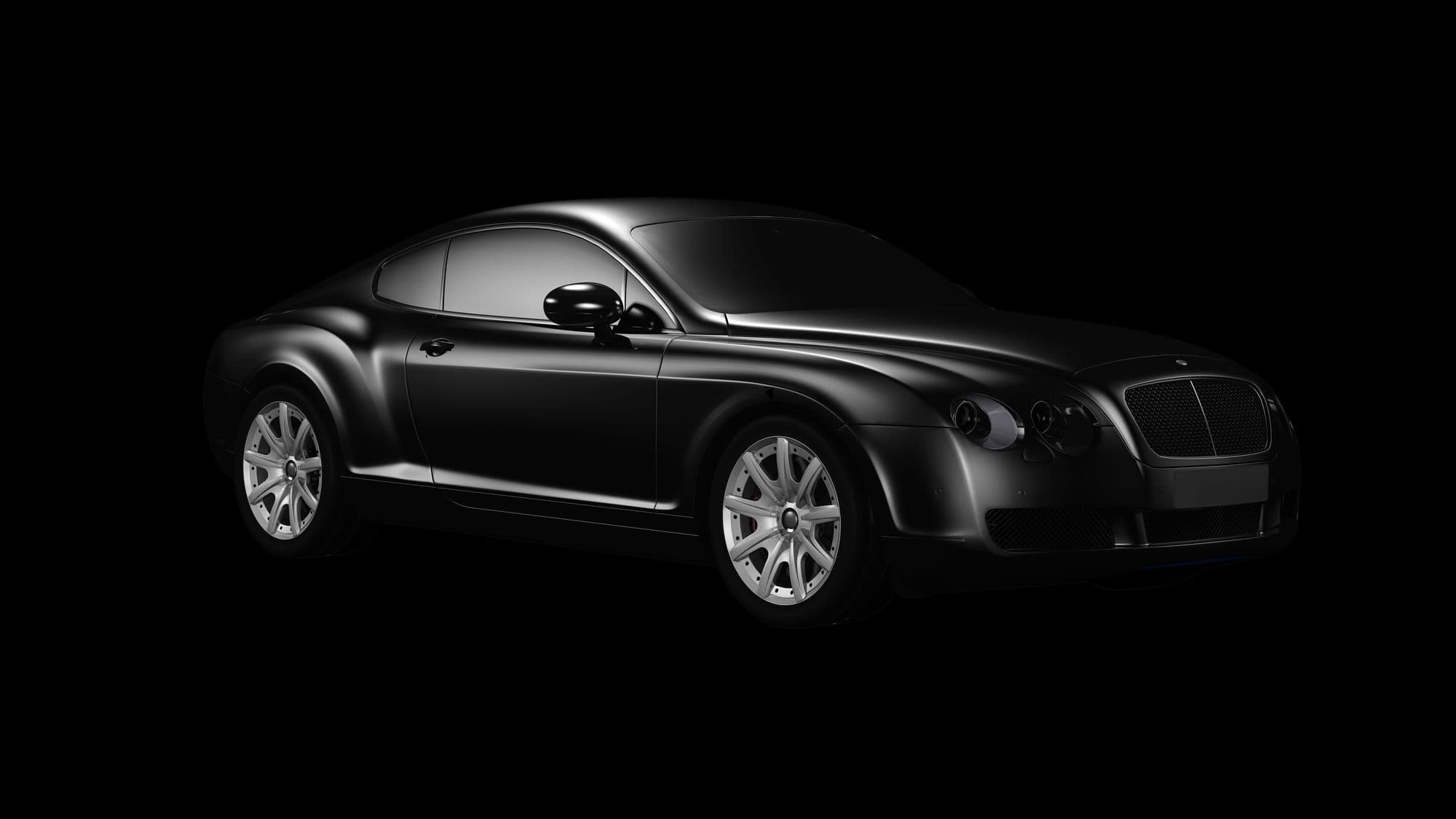 A car photographed in a dark studio, three-quarter front view